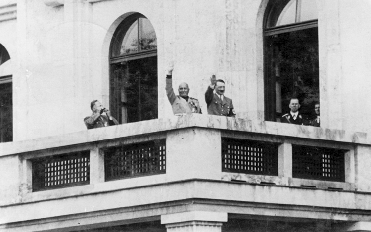 Adolf Hitler and Benito Mussolini wave at the crowd from the Führerbau balcony in München